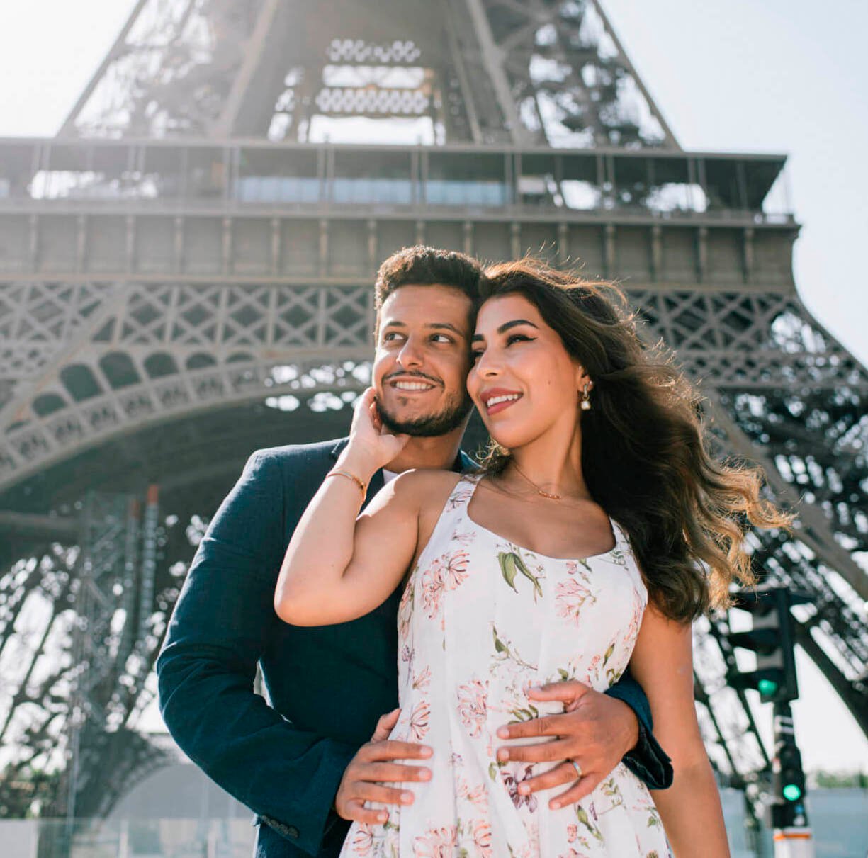 Romantic couple posing in front of the Eiffel Tower during vacation in Paris